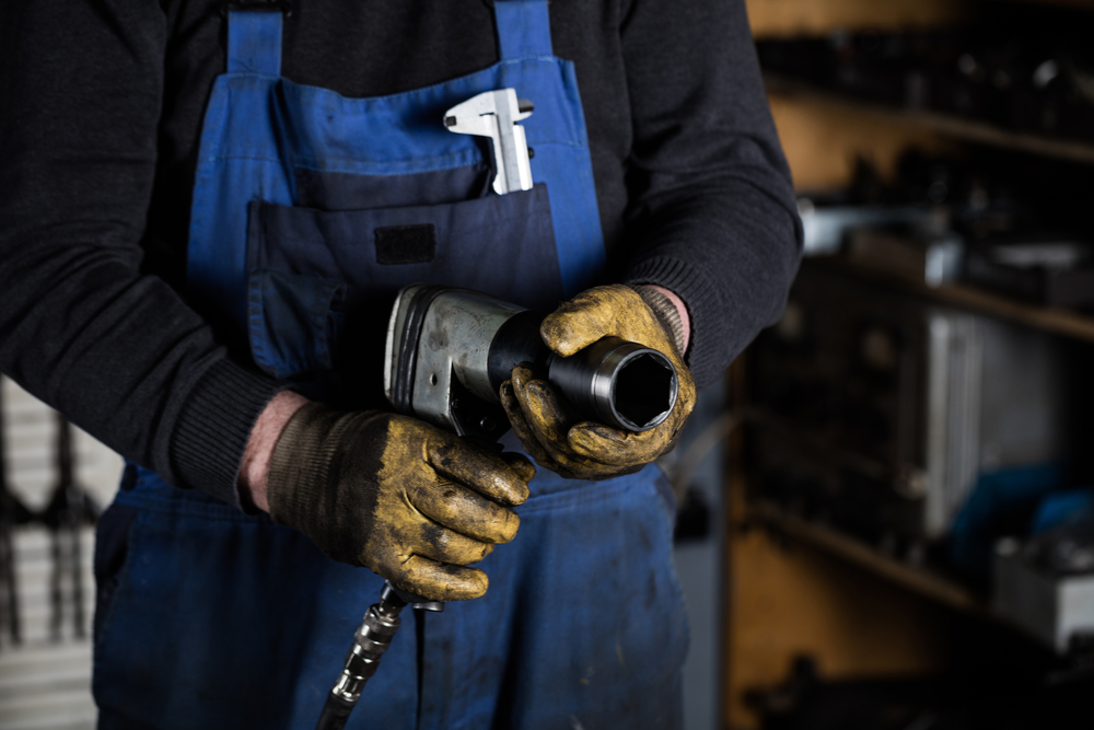 mechanic holding impact wrench