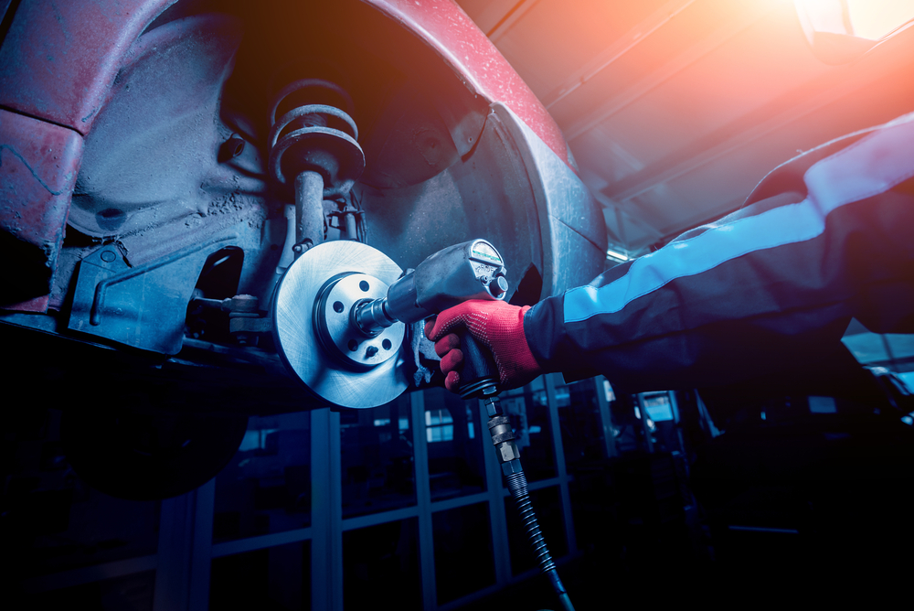 impact wrench being used on wheel axle