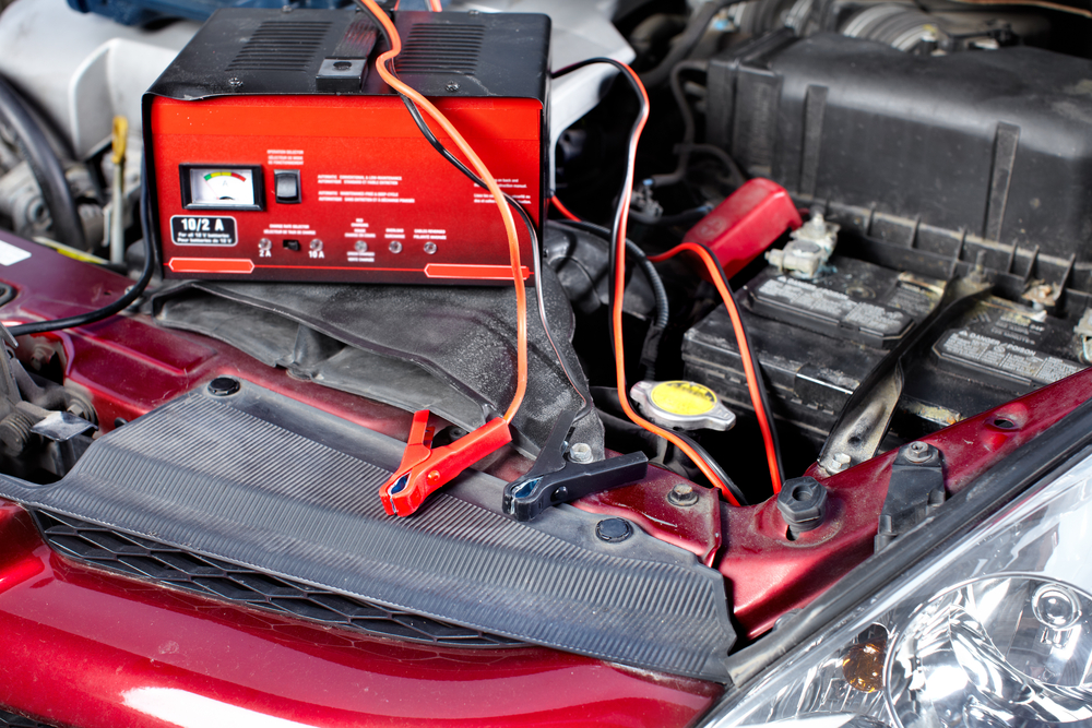 battery charger sitting on top of car engine bay