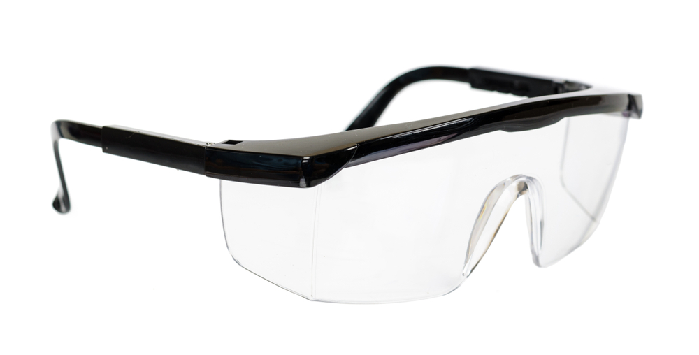 Safety glasses over white background