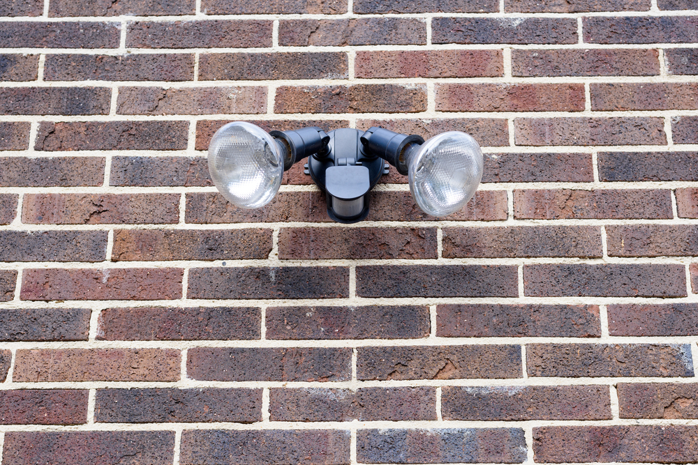 motion detector security light against brick wall