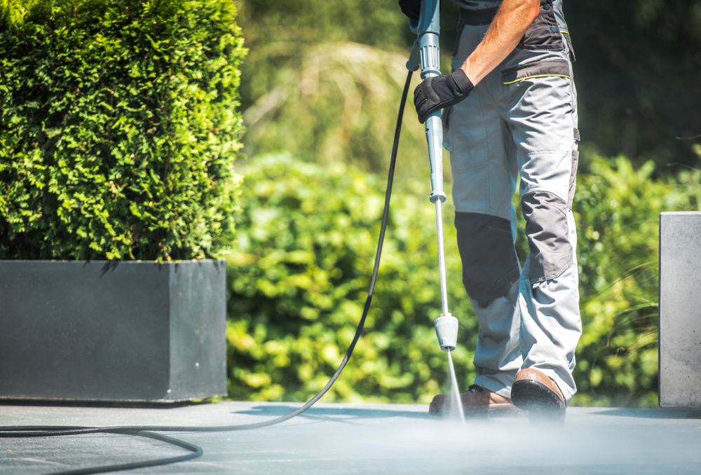 man using power washer outdoors