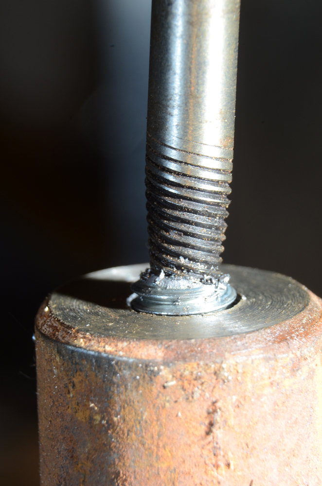 Bolt extraction tool being used to remove a broken bolt