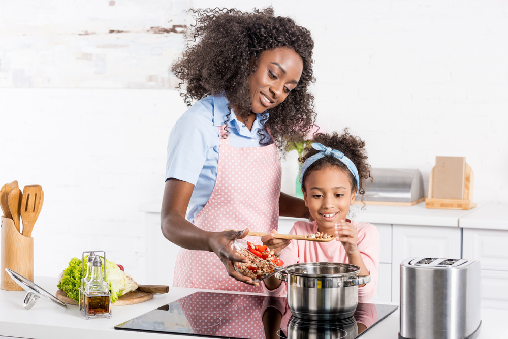 Family cooking over electric stove