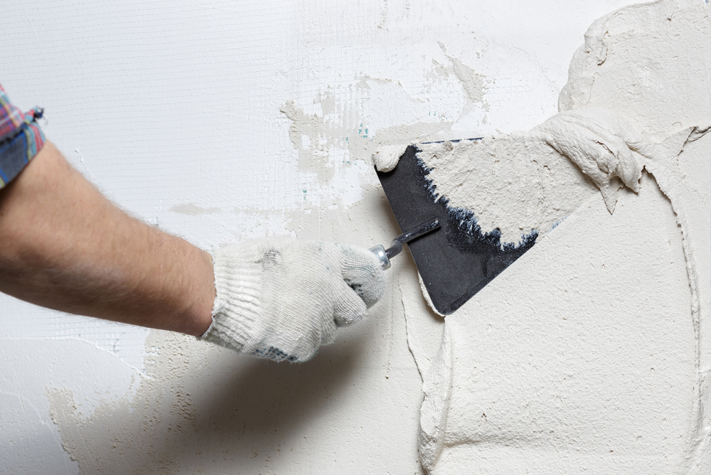 Spreading plaster on wall