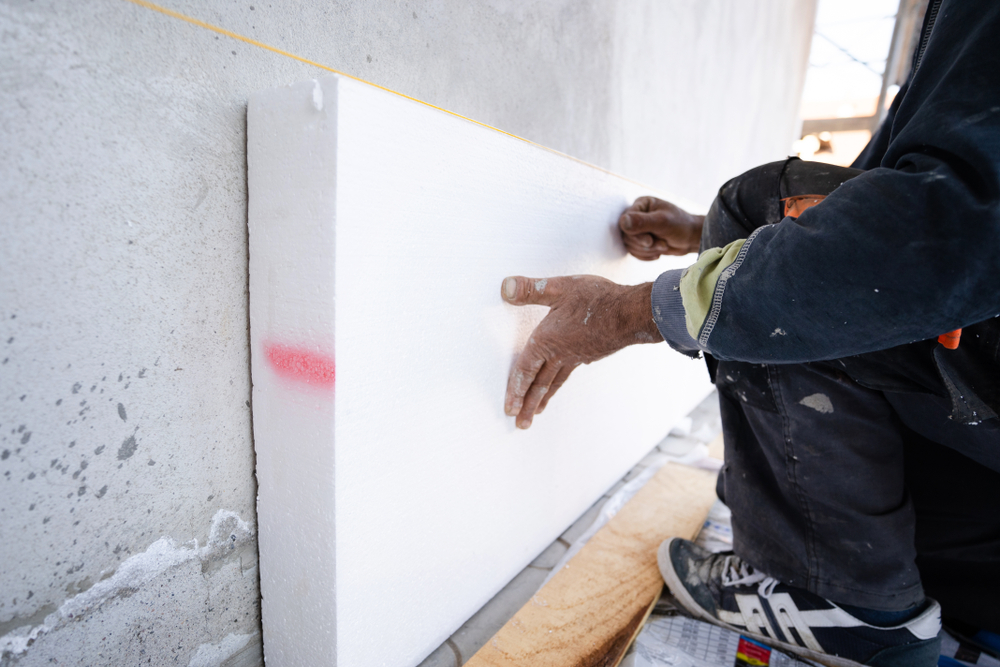 Worker installing foam board