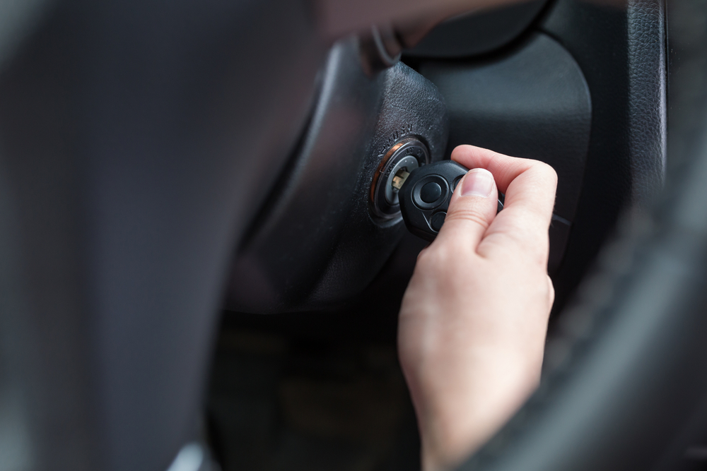 hand removing key from car ignition