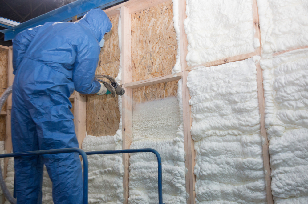 worker installing spray foam insulation