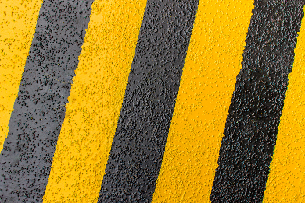 A black and yellow concrete floor painted in non-slip paint