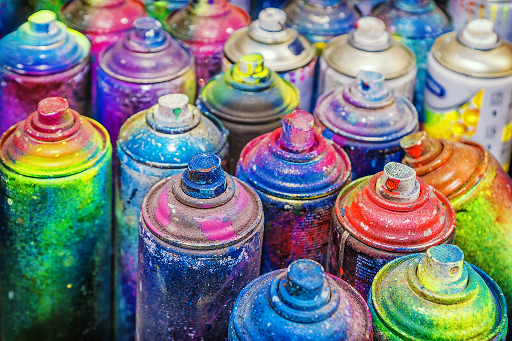 paint-covered cans of used spray paint