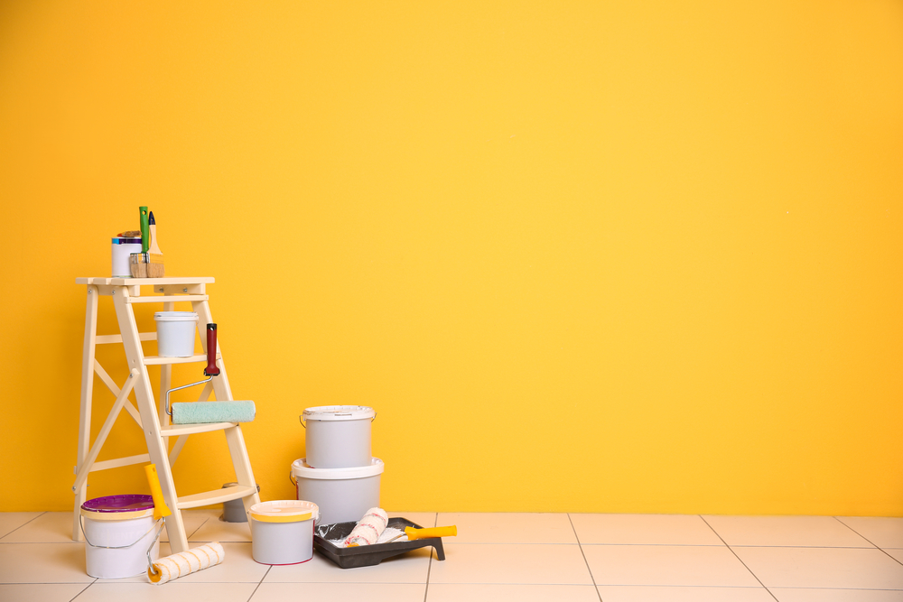 paint tools and yellow wall