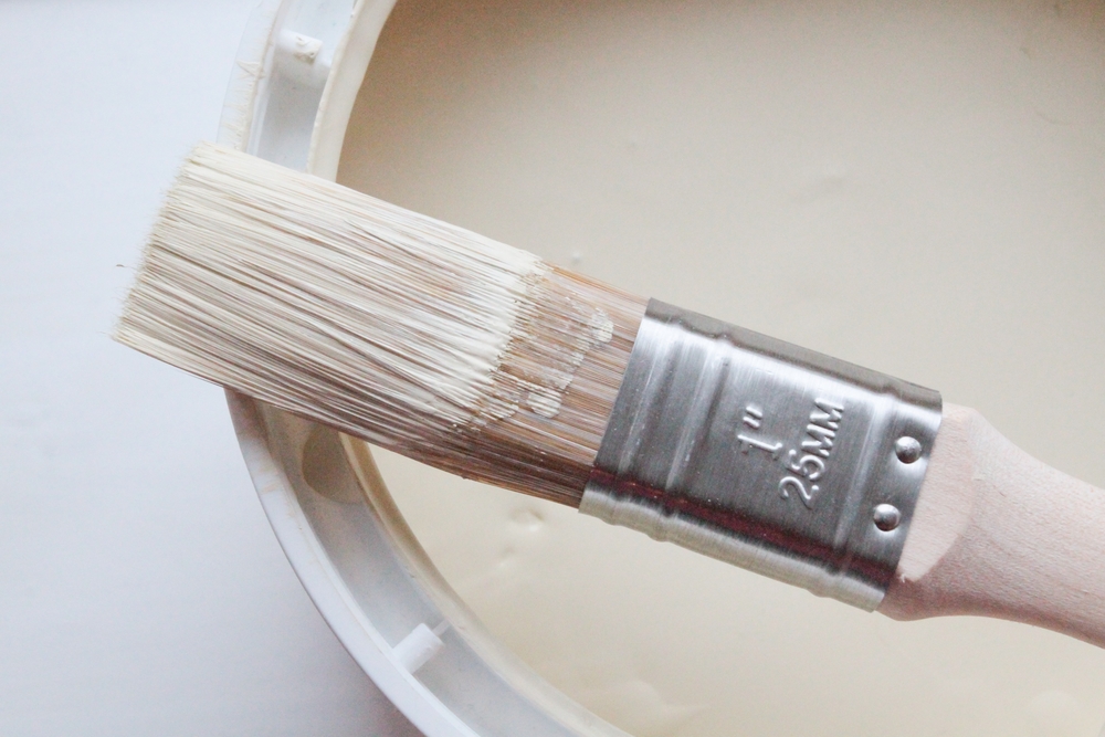 paintbrush on edge of paint can