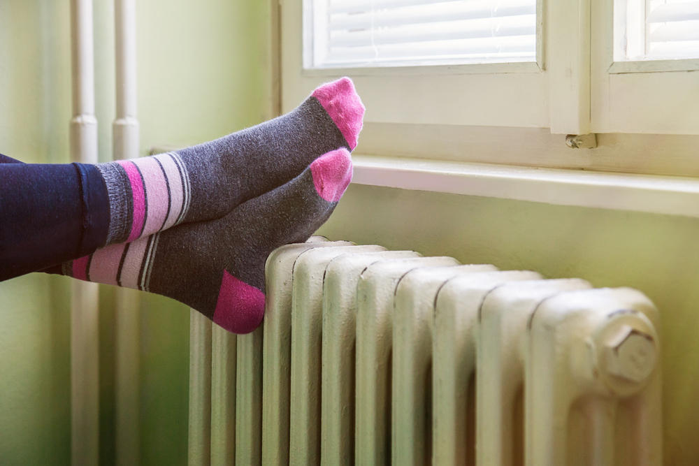 person relaxing with their feet balancing on a radiator