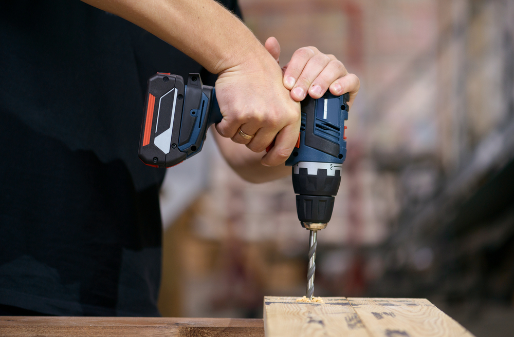 small drill making a hole in wood