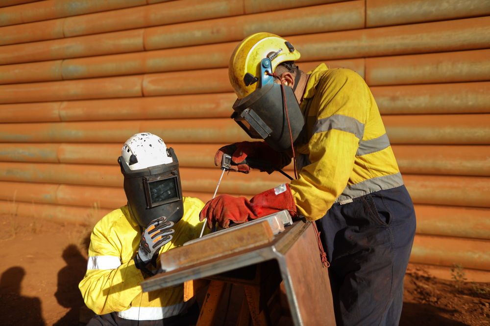 Welders wearing appropriate safety gear