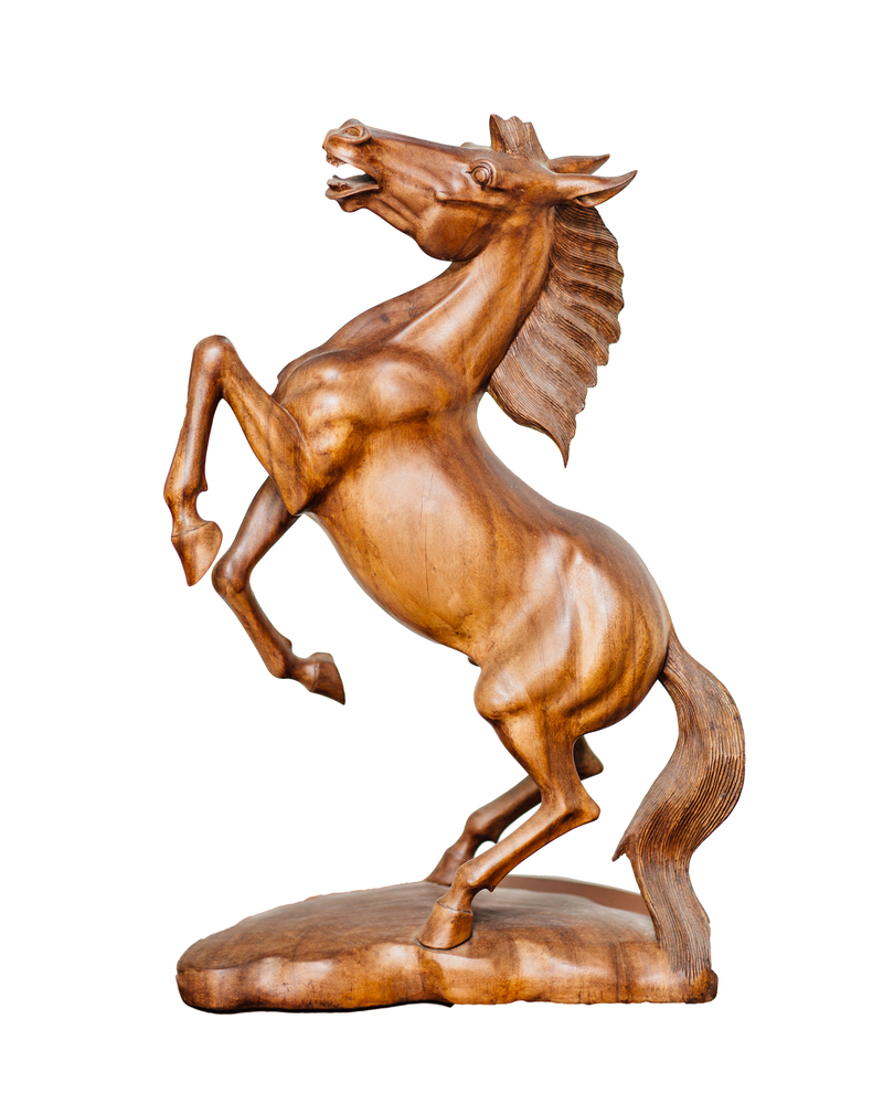 wooden sculpture of a rearing horse