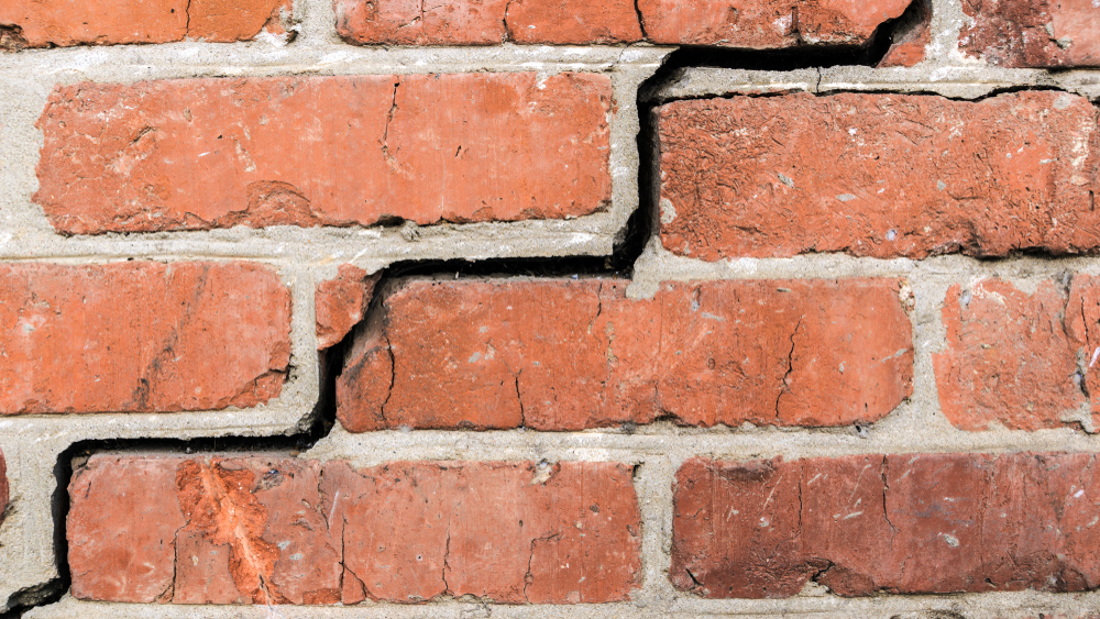 close-up of a stair-step crack in a brick wall